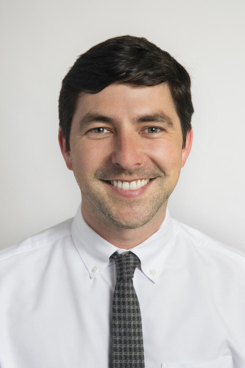 Photo of Santa Monica Mobility Manager Jason Kligier, smiling in a white button up & dark plaid tie