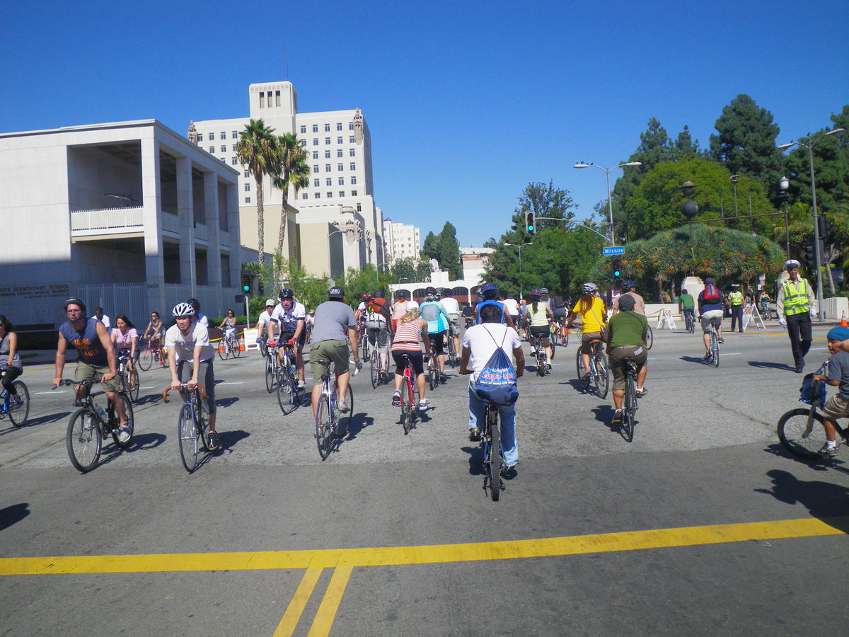 People riding bikes celebrate a street closure in Los Angeles where only cyclists and pedestrians are permitted.