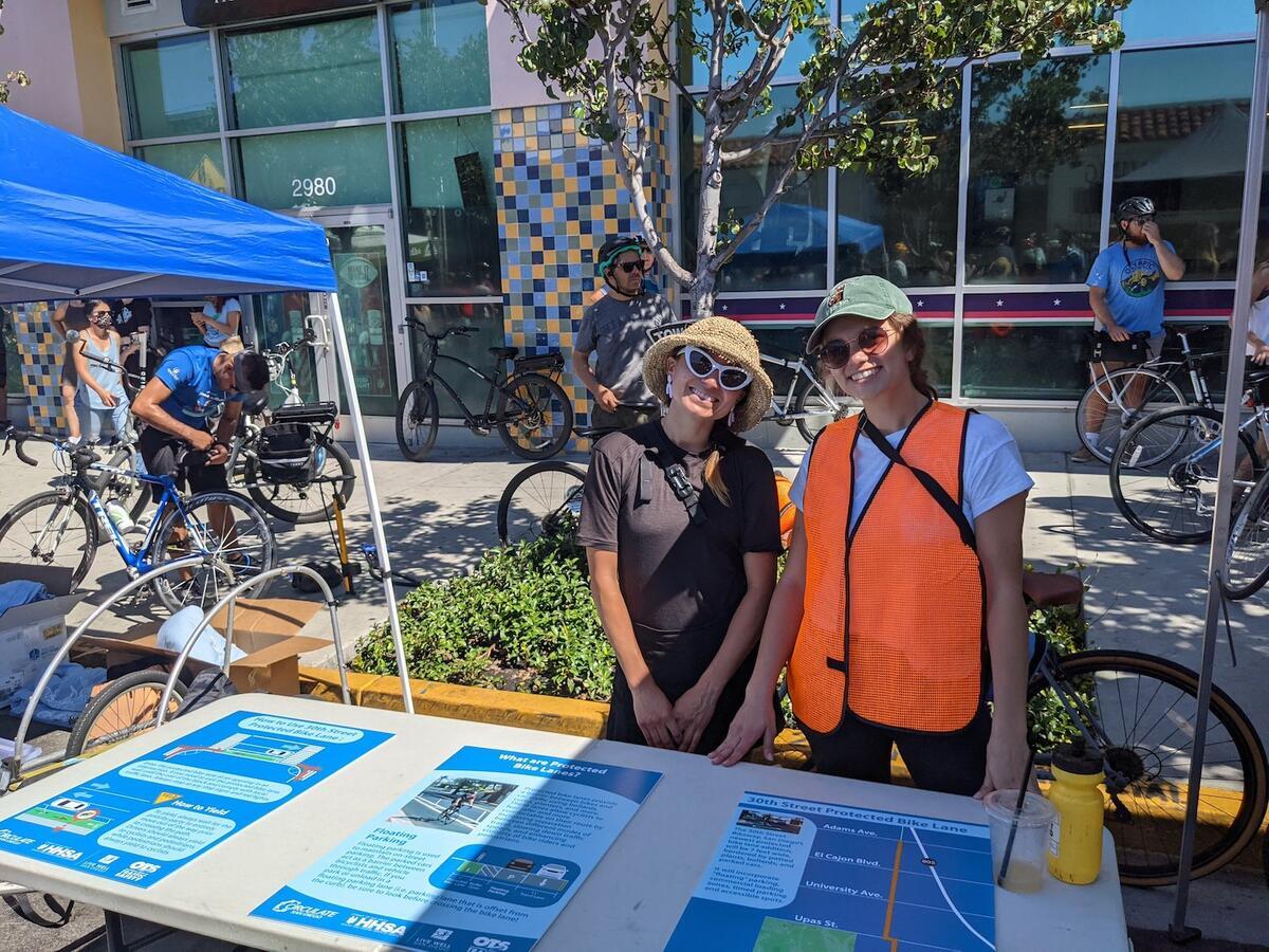 Photo of two Circulate San Diego staff at a tabling event to promote Vision Zero