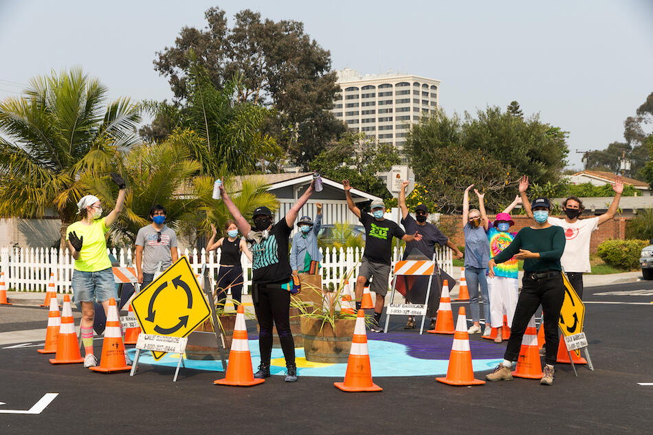Group photo of installation of roundabout for Reimagine 19th project