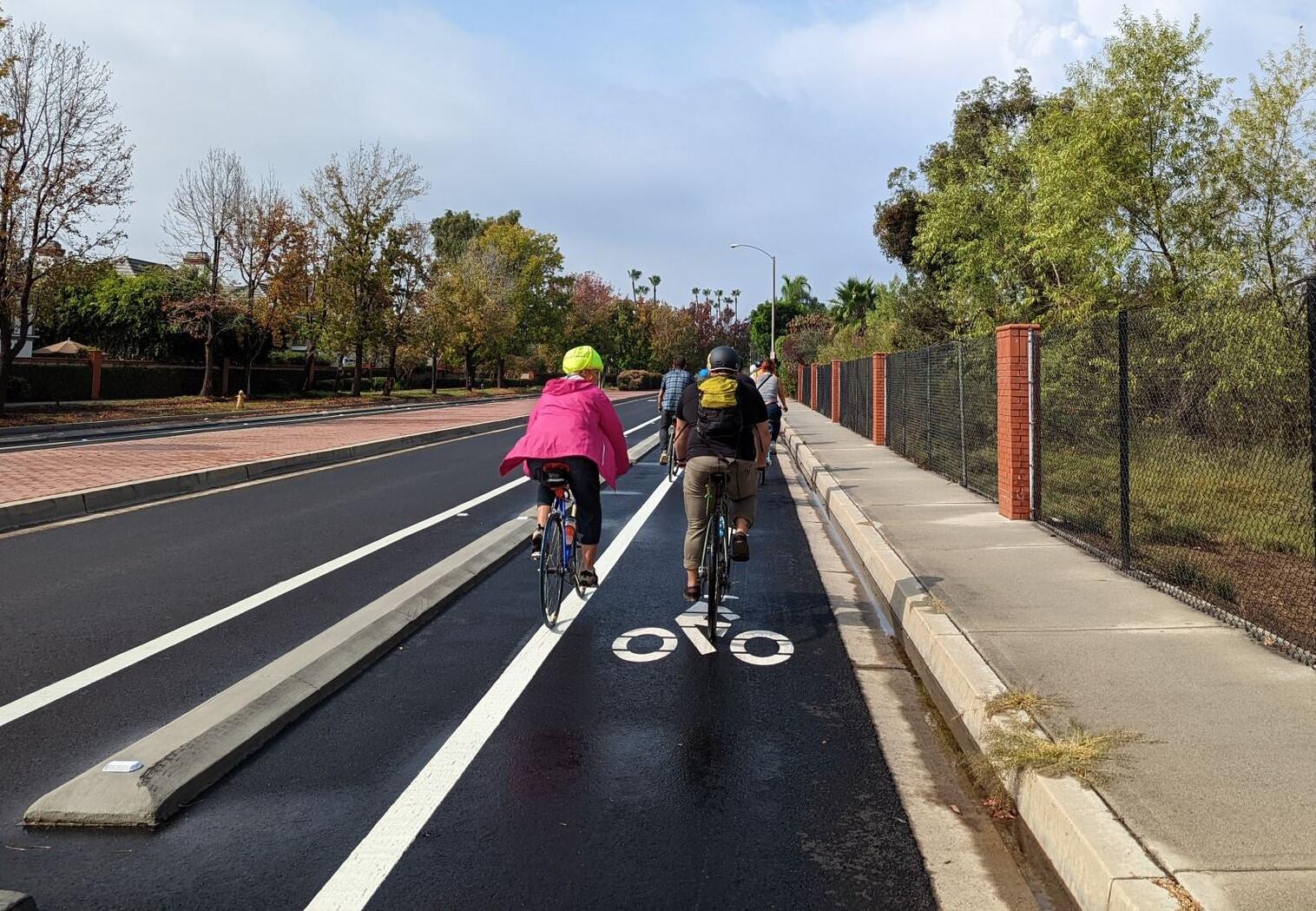 People bike on a newly constructed separated bikeway in Long Beach, California.