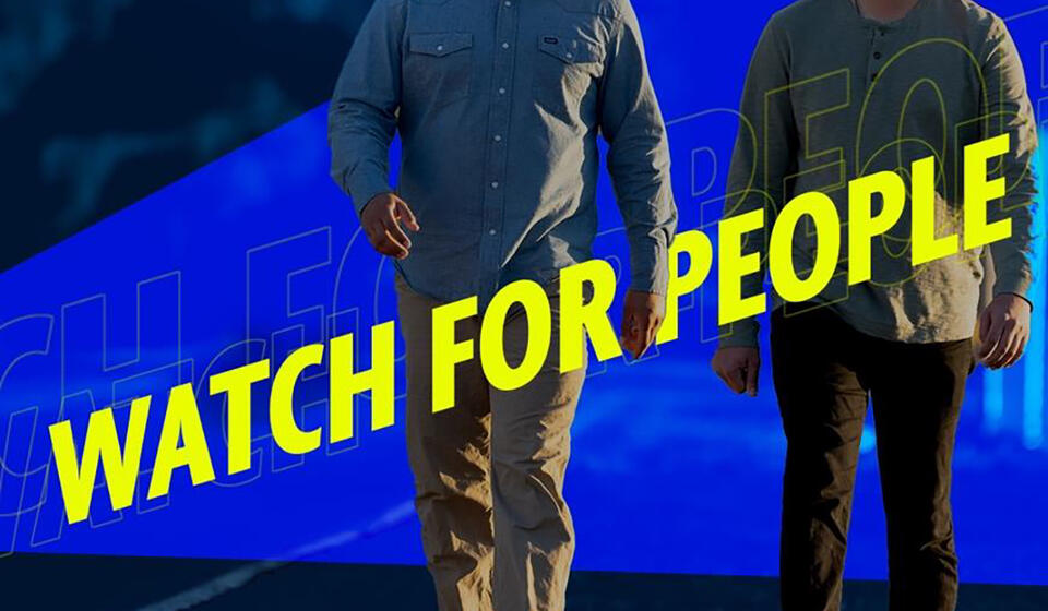 People walking with text “Watch for People” and “Safer People Keep Friends Safe” overlaid.