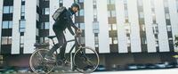 Bicyclist in front of a multistory building