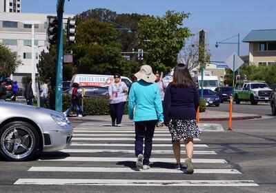 People walking in a crosswalk in Emeryville, CA