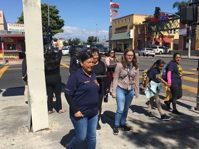 Karla Vilchys walking hand in hand with her child during the South LA CPBST Site Visit